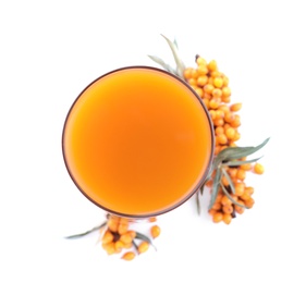 Photo of Delicious sea buckthorn juice and fresh berries isolated on white, top view