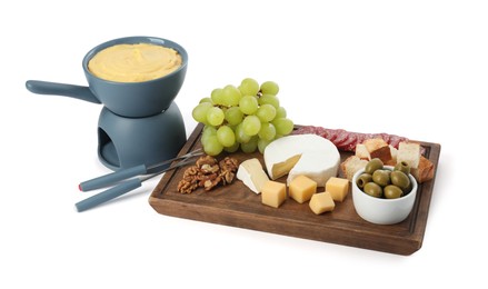 Fondue with tasty melted cheese, forks and different snacks isolated on white