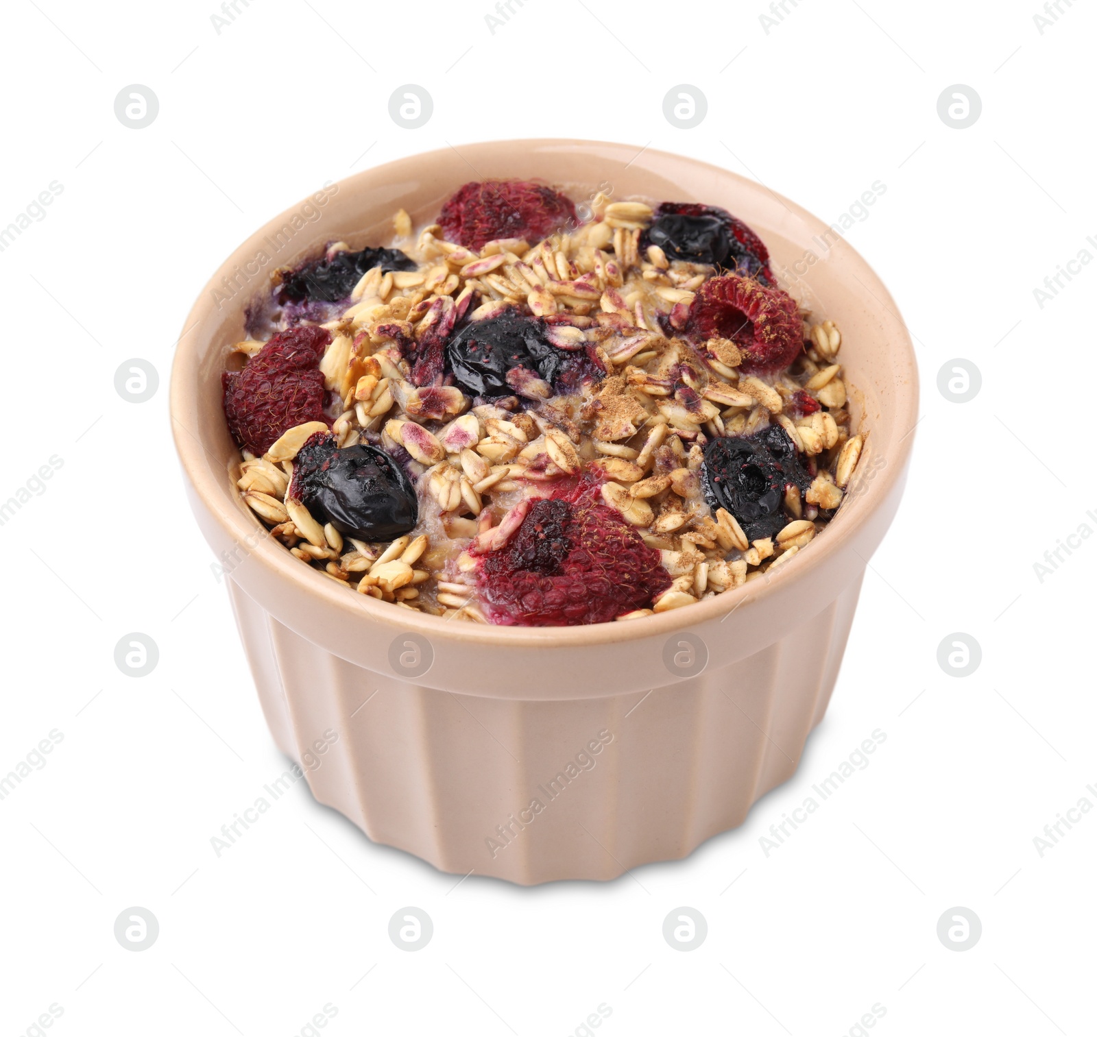 Photo of Tasty baked oatmeal with berries in bowl isolated on white