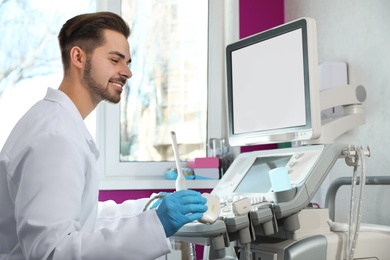 Sonographer using modern ultrasound machine in clinic