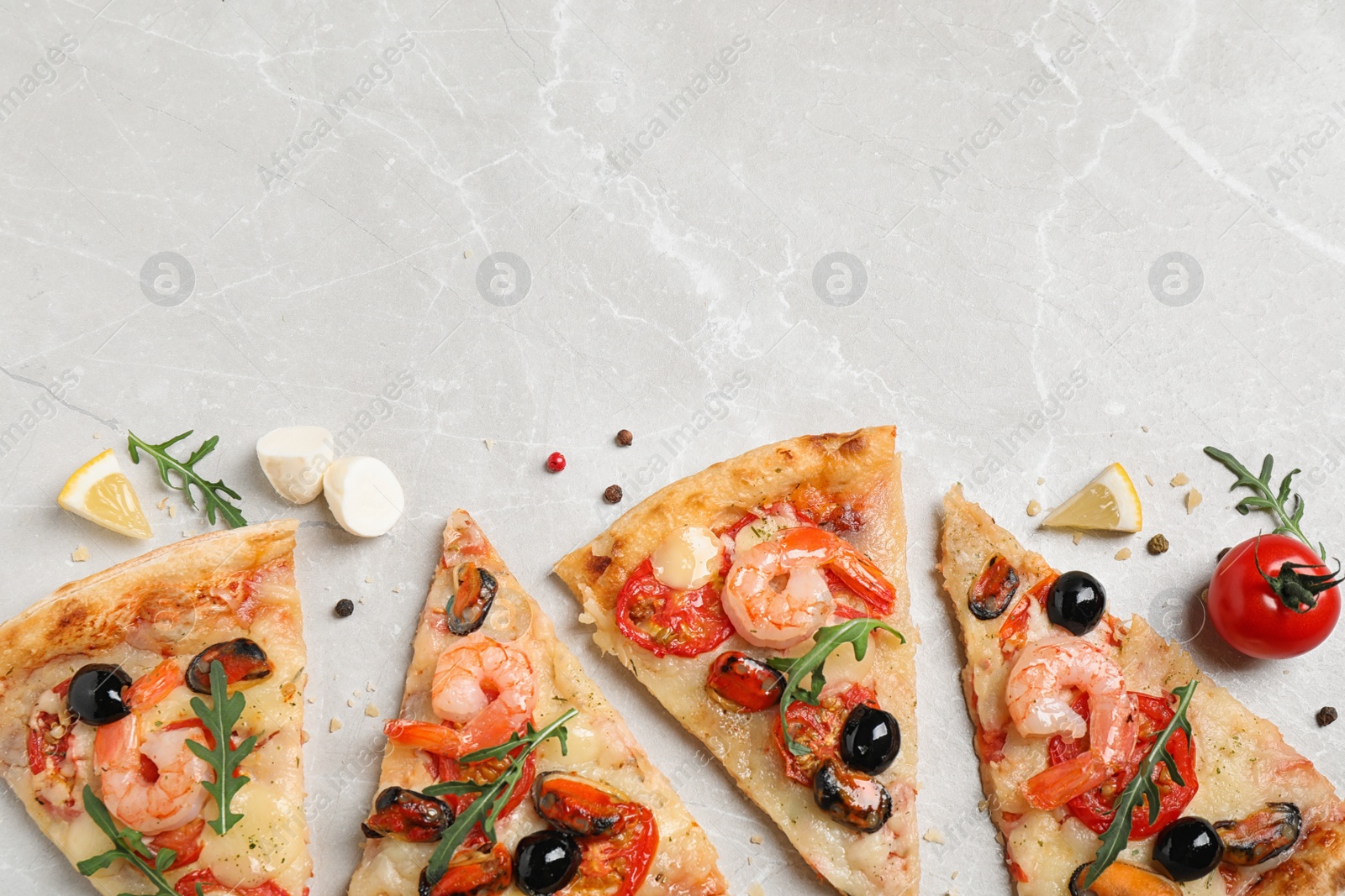 Photo of Tasty pizza with seafood and ingredients on light grey marble table, flat lay. Space for text