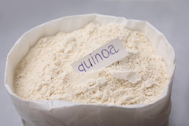 Photo of Sack with quinoa flour on light table, closeup