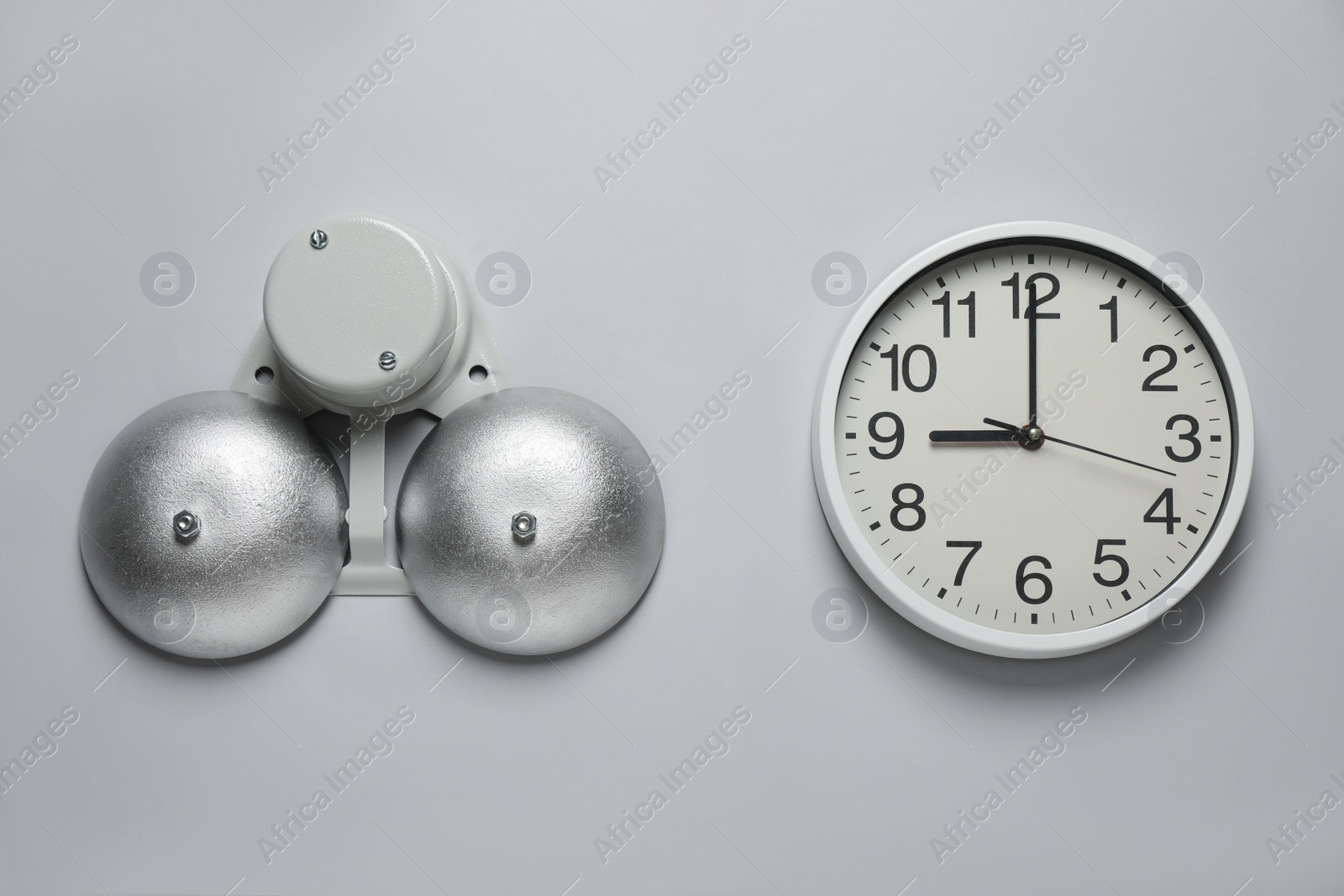 Photo of Modern electrical school bell and clock on white wall