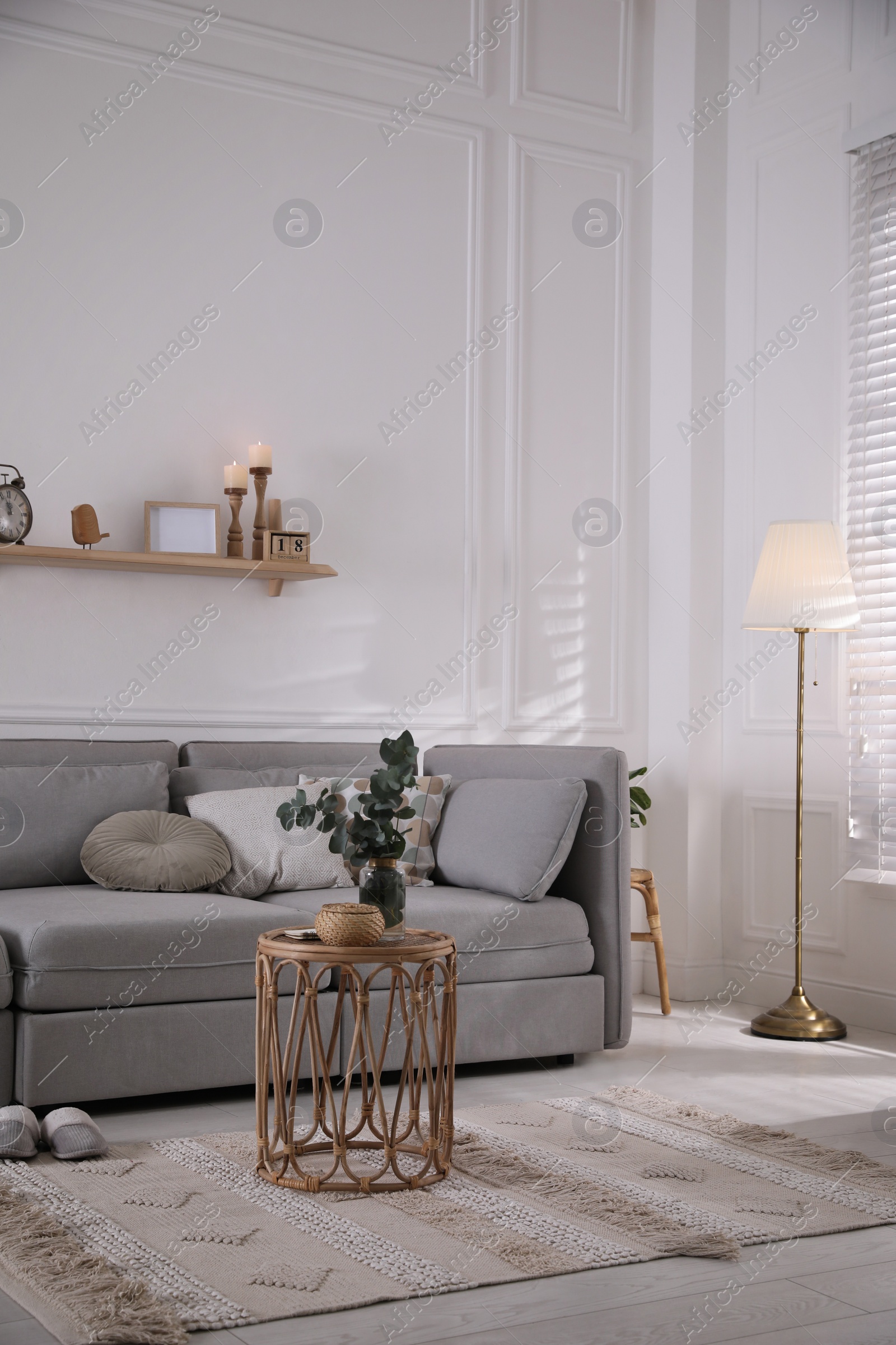 Photo of Living room with comfortable grey sofa and stylish interior elements