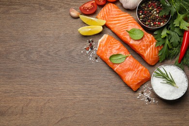 Fresh salmon and ingredients for marinade on wooden table, flat lay. Space for text