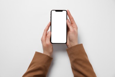 Photo of Woman with smartphone on white background, top view