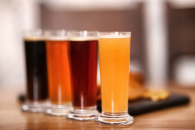 Photo of Beer tasting set served on wooden table