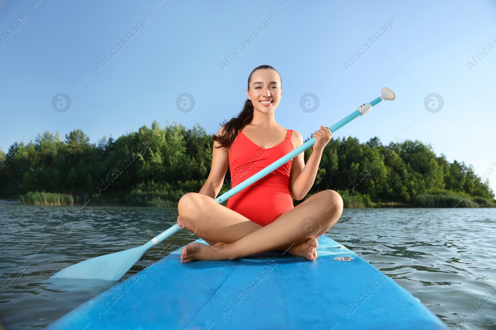 Photo of Woman paddle boarding on SUP board in river