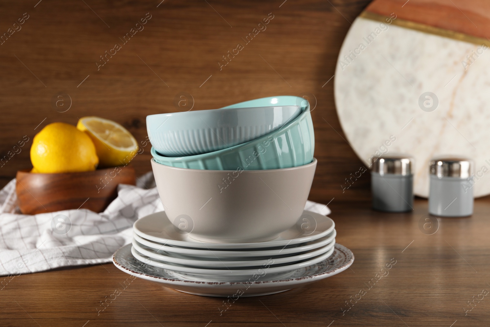 Photo of Stack of beautiful tableware on wooden table