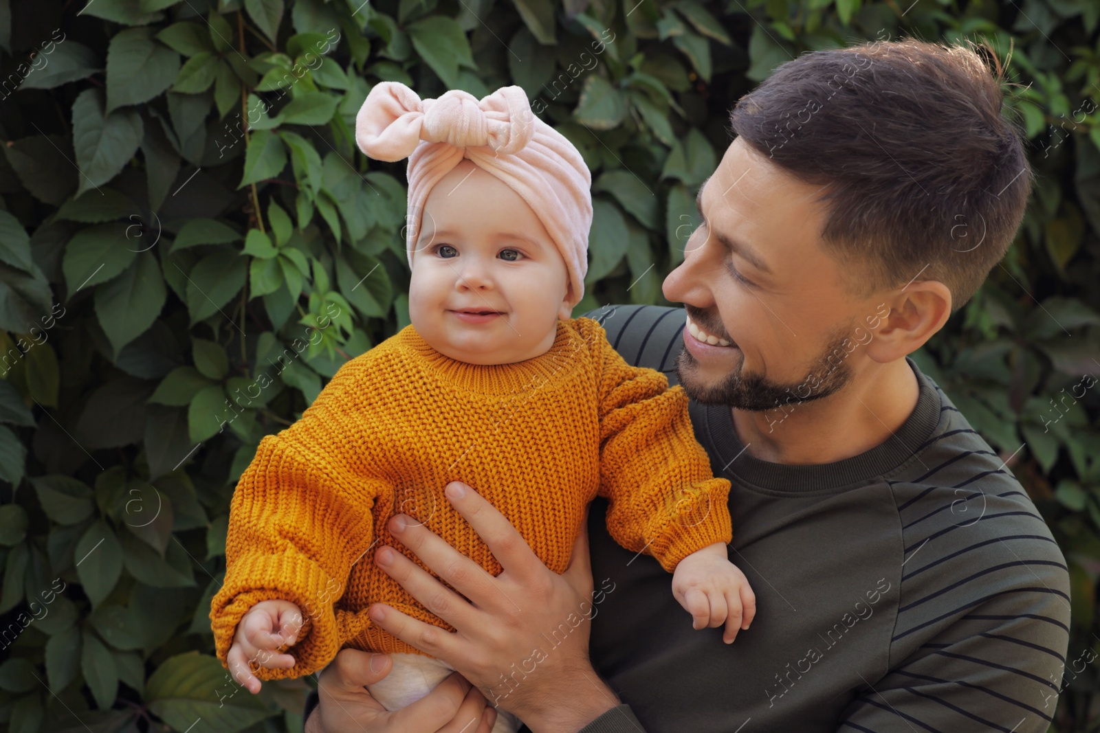 Photo of Happy father with his little baby outdoors on sunny day