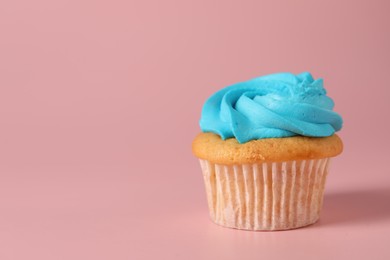 Photo of Delicious cupcake with bright cream on pink background, space for text