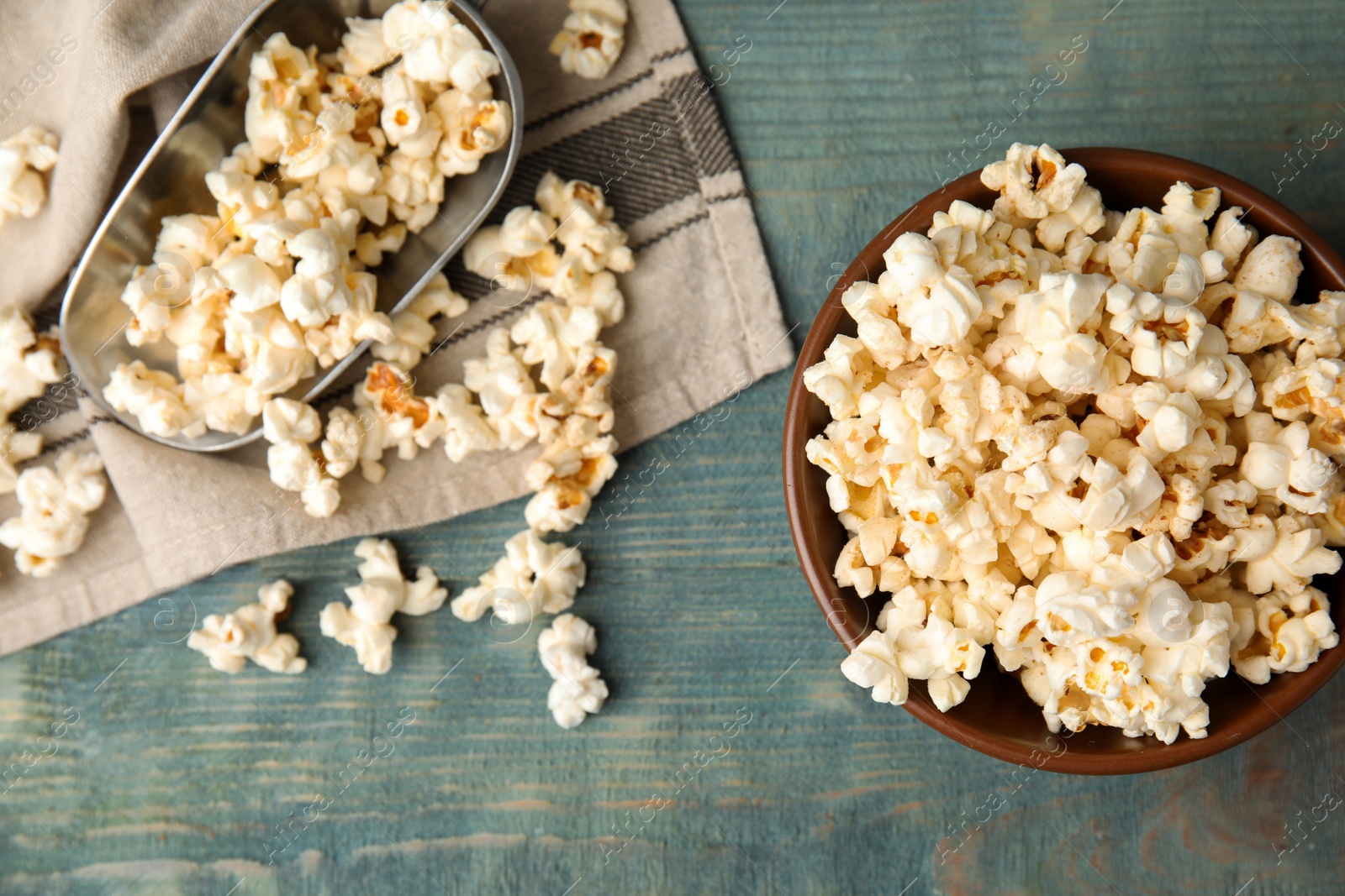 Photo of Flat lay composition with tasty pop corn on blue wooden table
