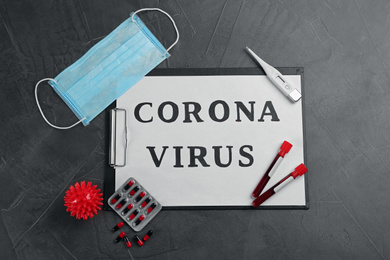 Paper with words CORONA VIRUS on grey stone background, flat lay