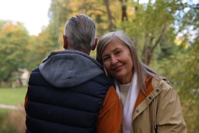 Portrait of affectionate senior couple in autumn park