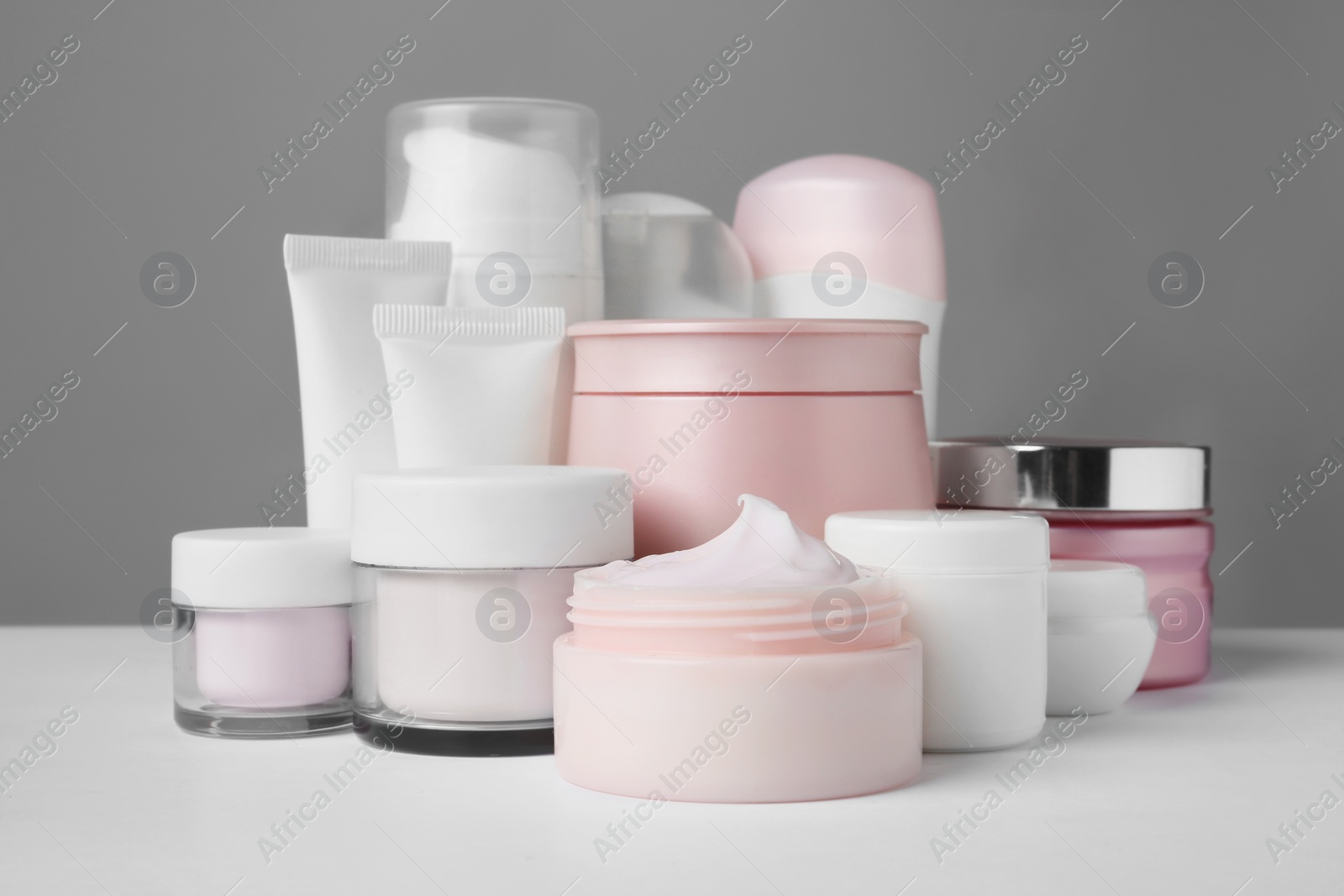 Photo of Different body care products on gray background