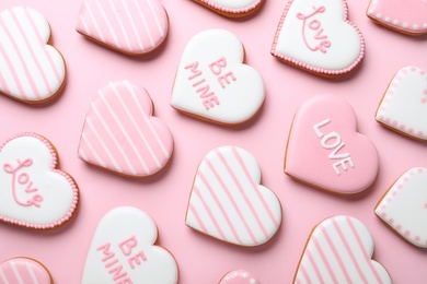 Photo of Decorated heart shaped cookies on pink background, flat lay. Valentine's day treat