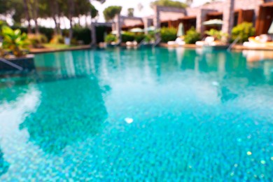 Photo of Luxury resort with outdoor swimming pool and sun loungers on sunny day, blurred view