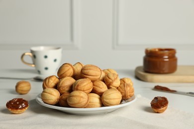 Homemade walnut shaped cookies with boiled condensed milk on table