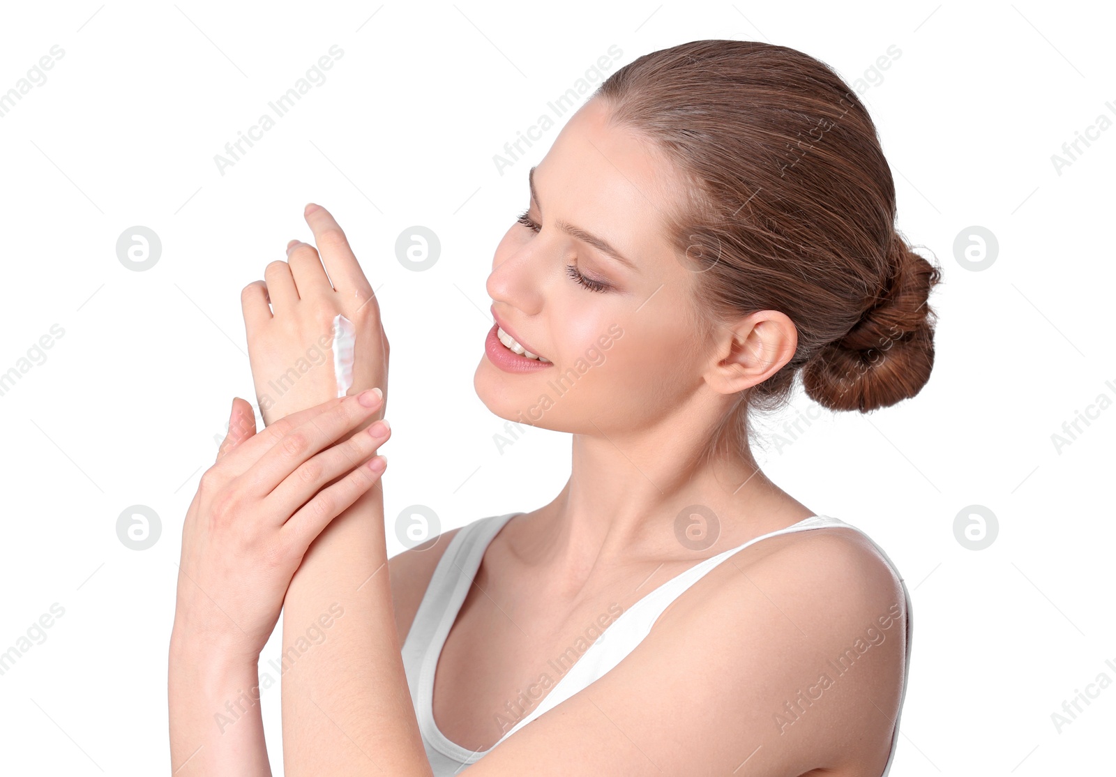 Photo of Young woman applying hand cream on white background