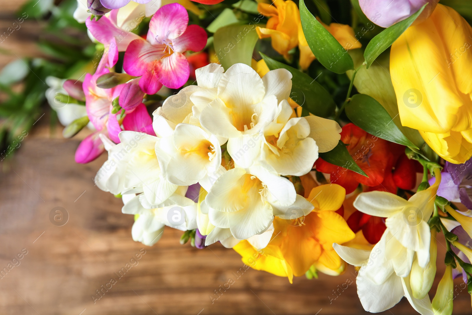 Photo of Beautiful bouquet of freesia flowers, top view