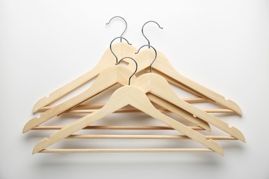 Wooden hangers on white background, top view