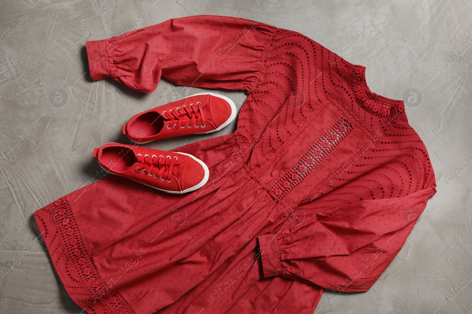 Photo of Stylish red dress and shoes on grey stone background, flat lay