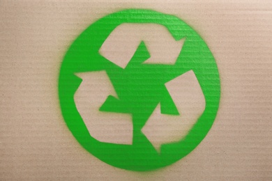Photo of Recycling symbol painted on cardboard, top view