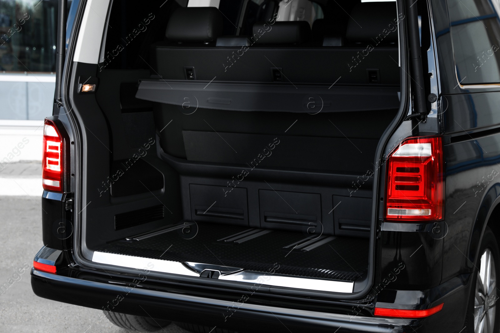 Photo of Modern car with open empty trunk outdoors