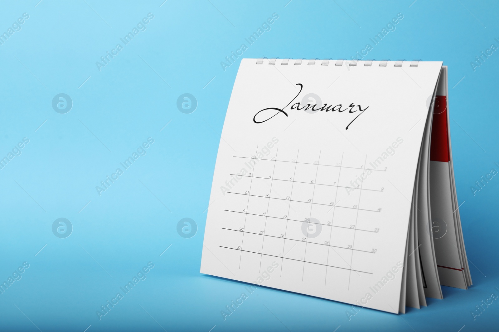 Photo of Paper calendar on light blue background, space for text. Planning concept