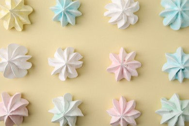 Photo of Delicious meringue cookies on beige background, flat lay