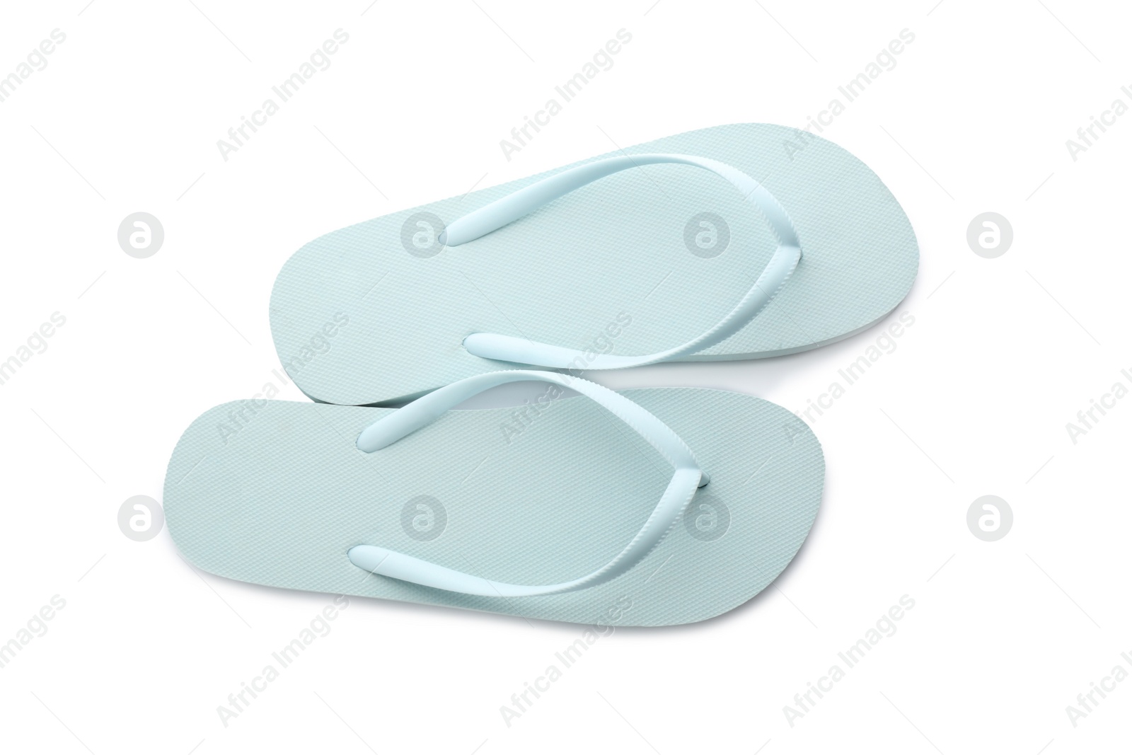 Photo of Stylish light blue flip flops on white background, top view. Beach object