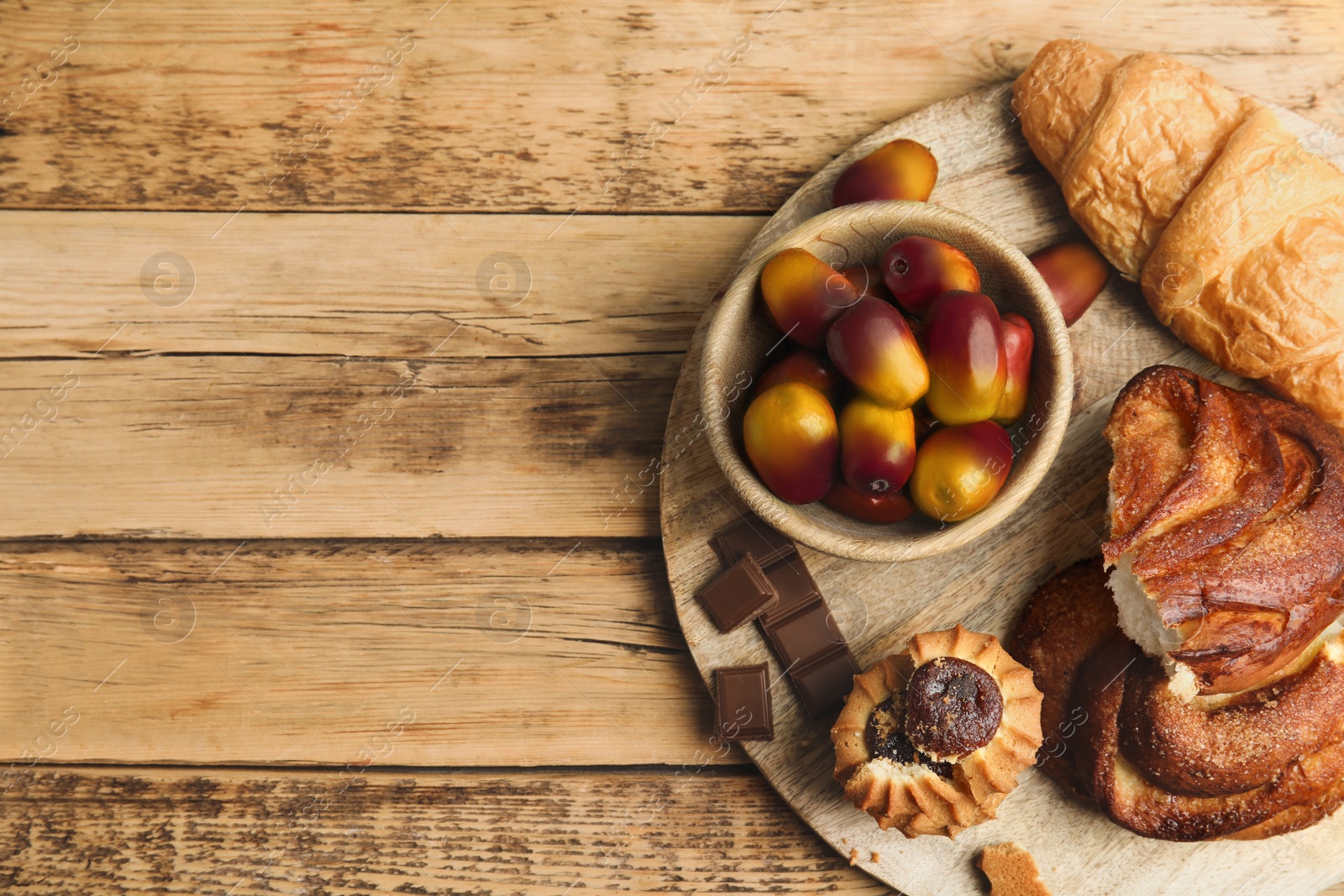 Image of Fresh ripe palm oil fruits and sweets on wooden table, top view. Space for text