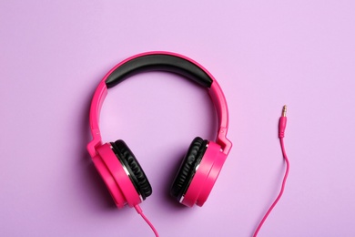 Photo of Stylish headphones on color background, top view