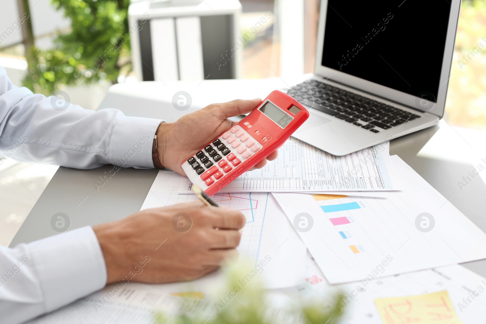 Photo of Tax accountant working with documents at table