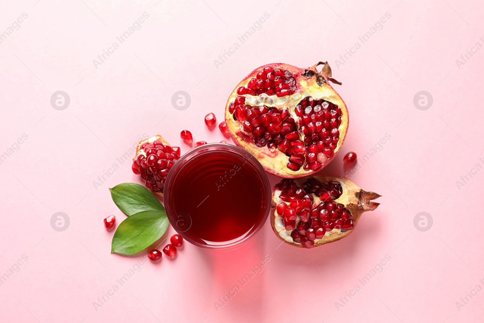 Photo of Glass of pomegranate juice and fresh fruits on color background, top view