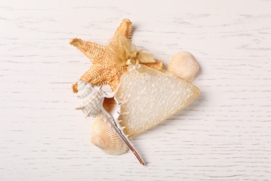 Photo of Scented sachet, starfish and sea shells on white wooden table, flat lay