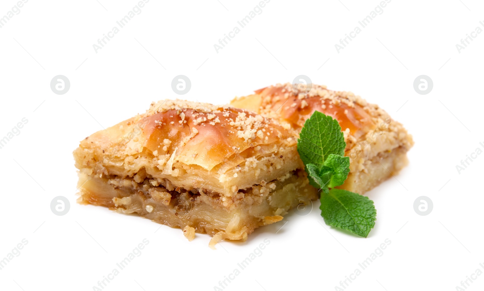 Photo of Eastern sweets. Pieces of tasty baklava with mint isolated on white