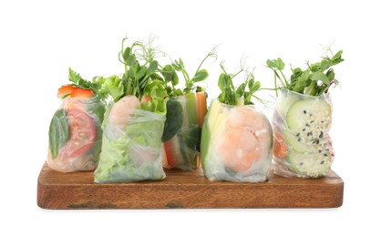 Photo of Many different delicious rolls wrapped in rice paper isolated on white