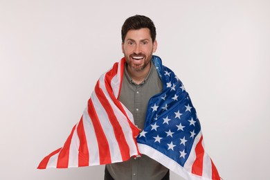 Photo of 4th of July - Independence Day of USA. Happy man with American flag on white background