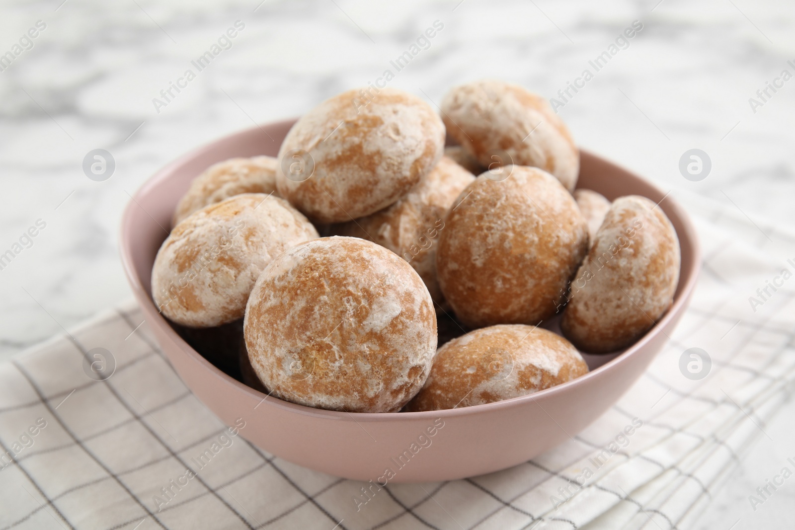 Photo of Tasty homemade gingerbread cookies in bowl on white marble table, closeup