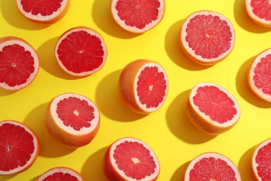 Fresh sliced ripe grapefruits on color background, flat lay