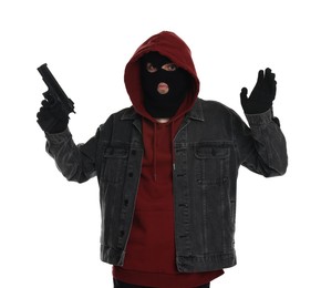 Thief in balaclava raising hands with gun on white background