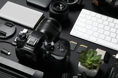 Camera, computer keyboard and video production equipment on black background