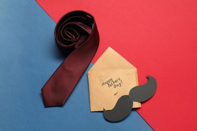 Photo of Card with phrase Happy Father's Day, paper mustache and necktie on color background, flat lay