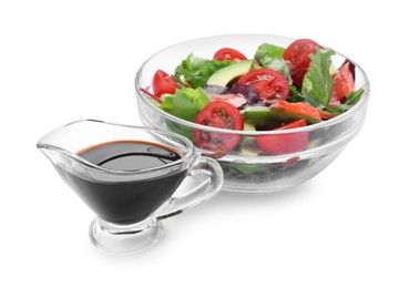 Tasty soy sauce and bowl with salad isolated on white