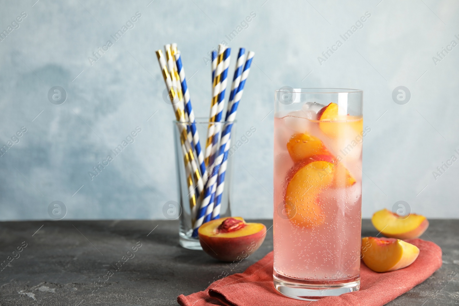 Photo of Tasty peach cocktail on table. Refreshing drink