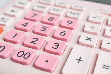 Closeup view of pink calculator as background