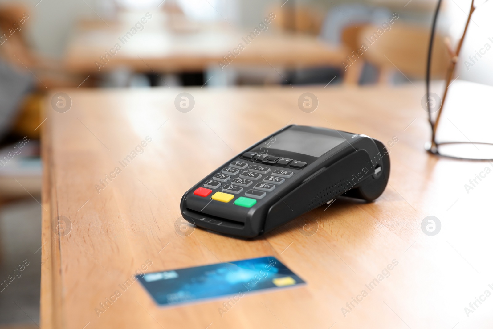 Photo of Credit card machine for non cash payment on wooden table indoors