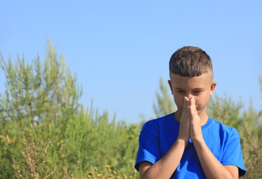 Photo of Little boy suffering from ragweed allergy outdoors