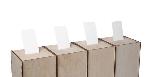 Photo of Wooden ballot boxes with votes isolated on white